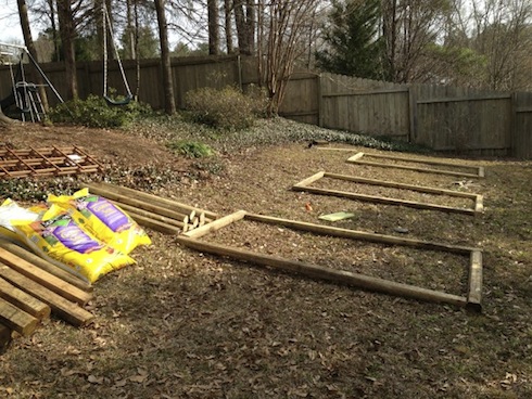 After cutting the necessary landscape timbers into half lengths, the next step was to lay out the location of the beds.